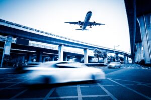 blurred street scene city with plane flying scaled 1